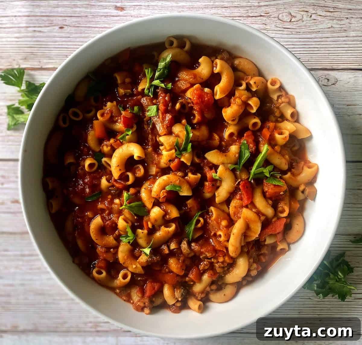 Hearty Vegan Goulash Recipe: Hungarian-Style Stew 2 Vegan Goulash Recipe in a bowl on a table with parsley garnish.