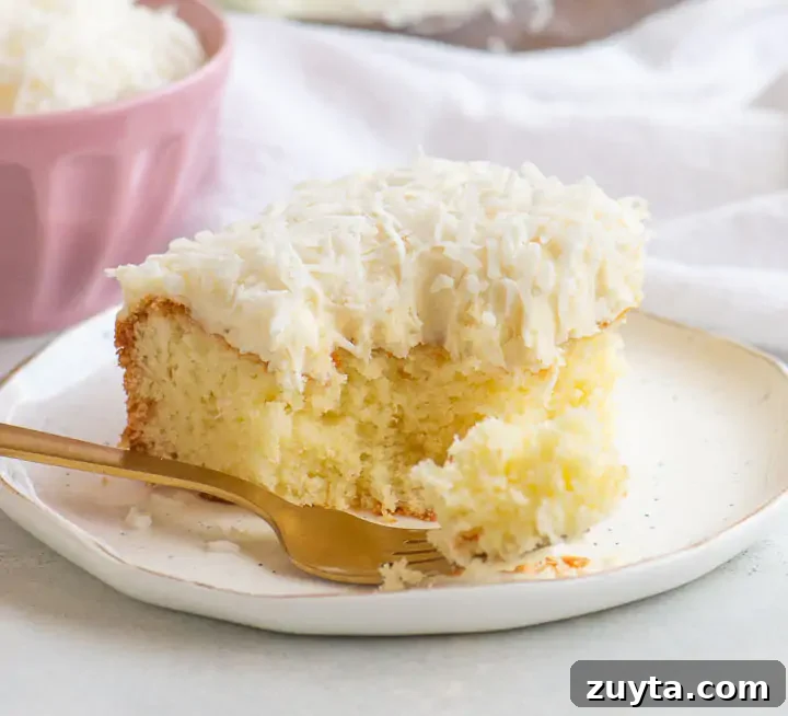 Moist Coconut Sour Cream Cake Recipe 5 slice of cake on a plate with a pink dish of coconut behind it