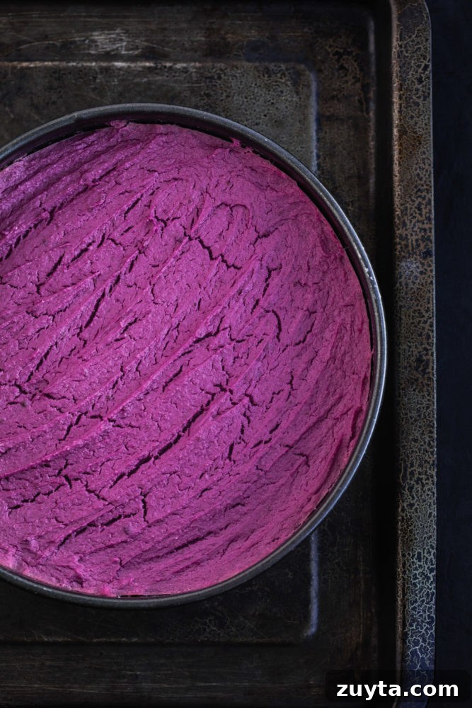 Purple sweet potato cheesecake, just out of the oven, overhead shot.