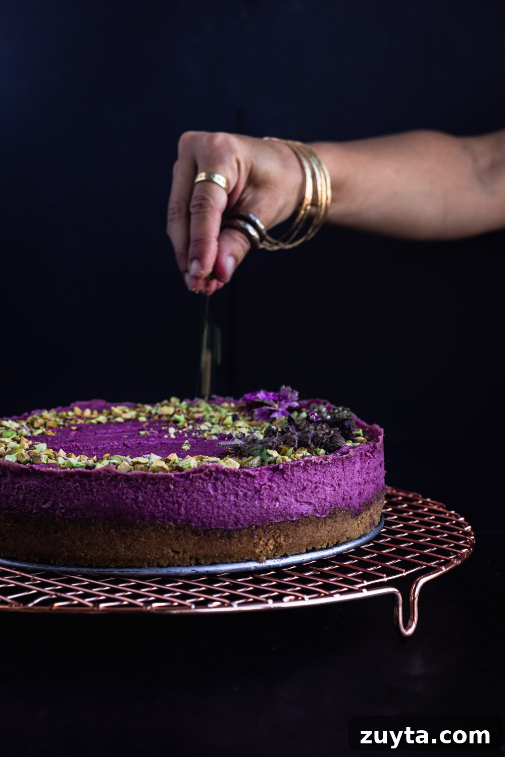 Chef Daniela Gerson sprinkling pistachios on her sweet potato cheesecake.