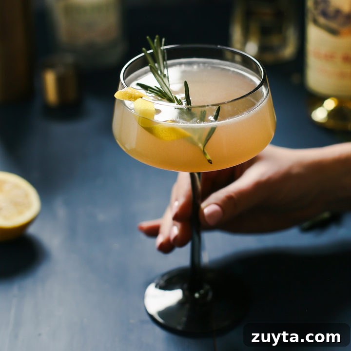 woman holding a glass of french blonde cocktail