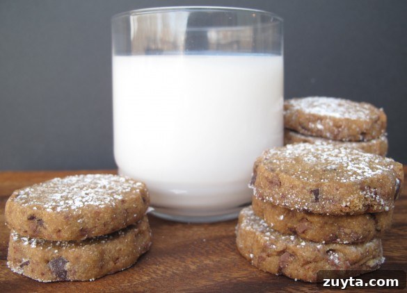two piles of Espresso Chocolate Shortbread Cookies and a glass of milk.